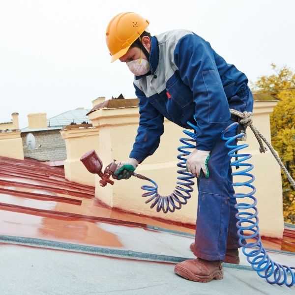 Roof painting in progress as Roofing Guys Adelaide applies protective coatings to extend the life of a metal roof.